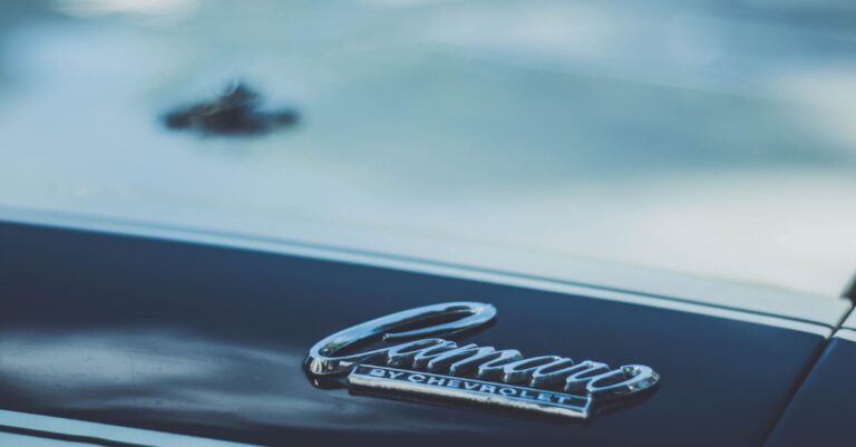 Detailed view of a Chevrolet Camaro emblem on a car hood, perfect for automotive enthusiasts.