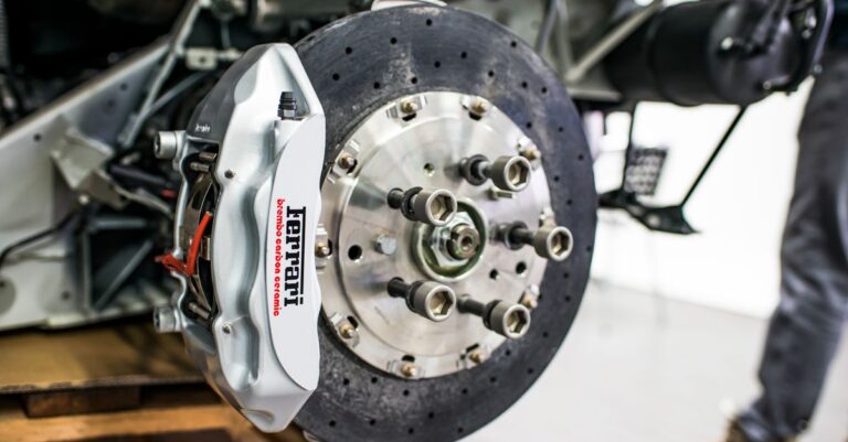 Detailed view of disc brake and caliper on a high-performance car, emphasizing precision and technology.
