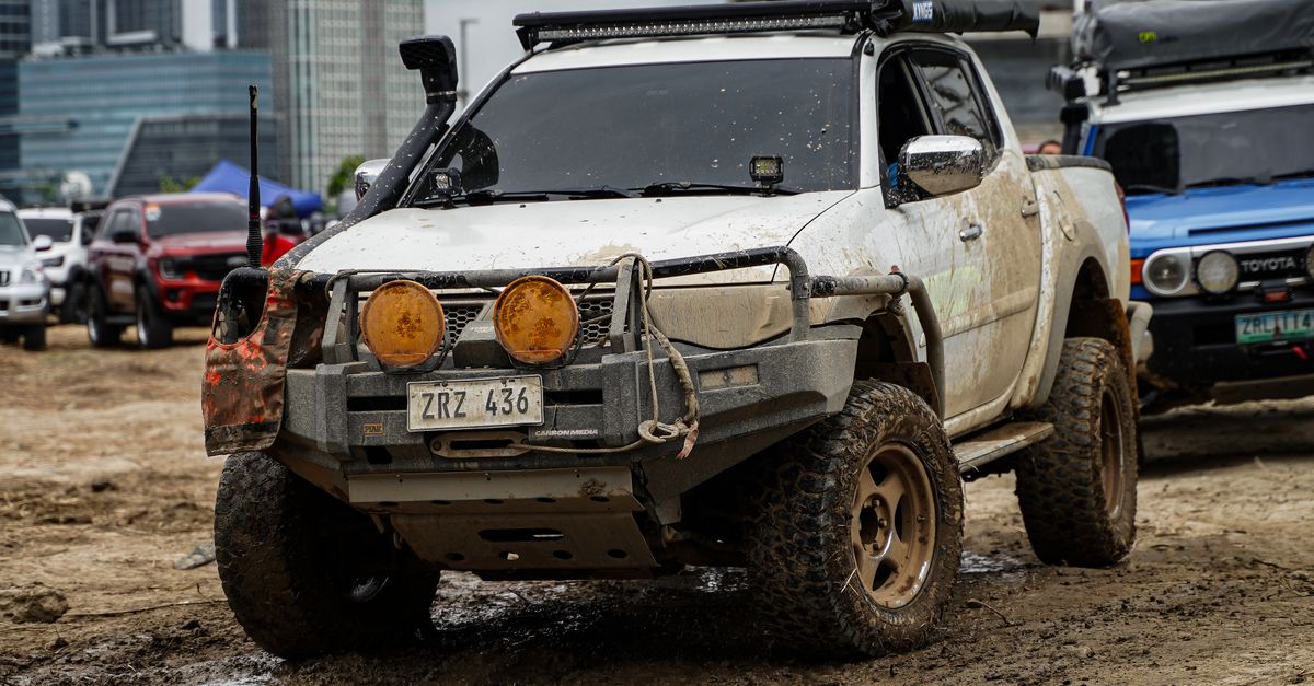 Mud-covered 4x4 truck participating in an off-road adventure event in Pasig City, Philippines.