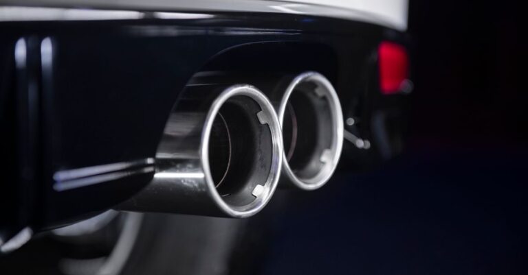 Detailed view of a chrome twin exhaust on a modern vehicle.