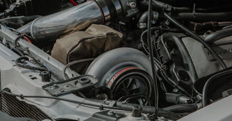 Close-up view of a modified Ford Mustang engine with turbocharger.
