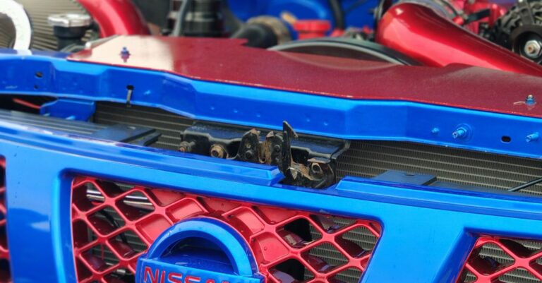 Close-up view of a modified Nissan engine with red and blue accents.
