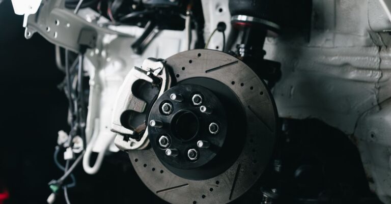 Detailed view of a vehicle's disc brake system with caliper, showcasing automotive technology.
