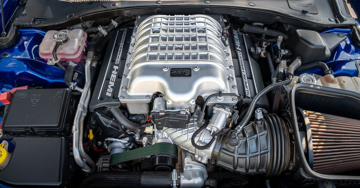 Detailed view of a powerful supercharged HEMI engine in a modern vehicle.